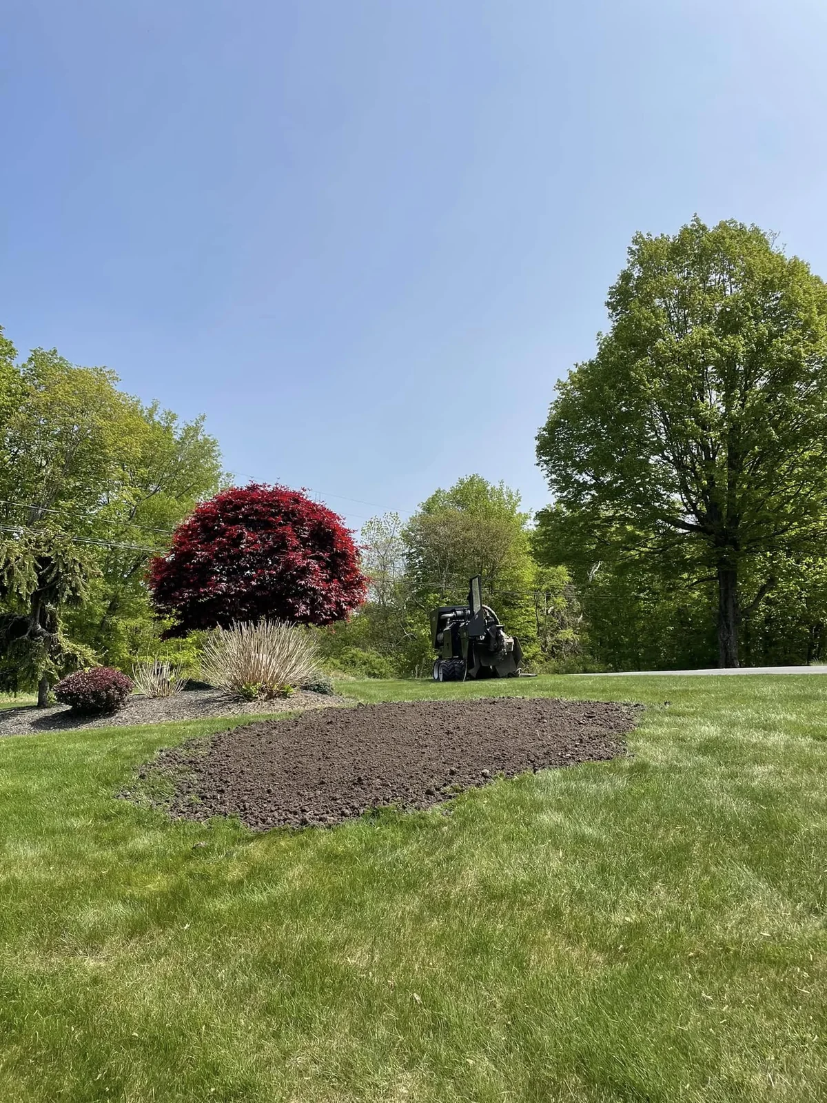 Fresh soil fill after the garden lawn stump was removed